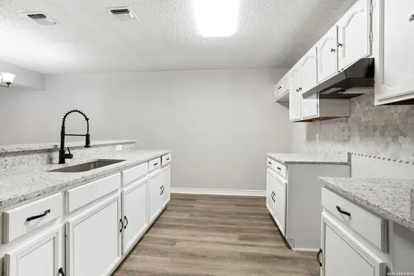 a kitchen with a sink and cabinets