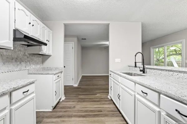 a kitchen with a sink and cabinets