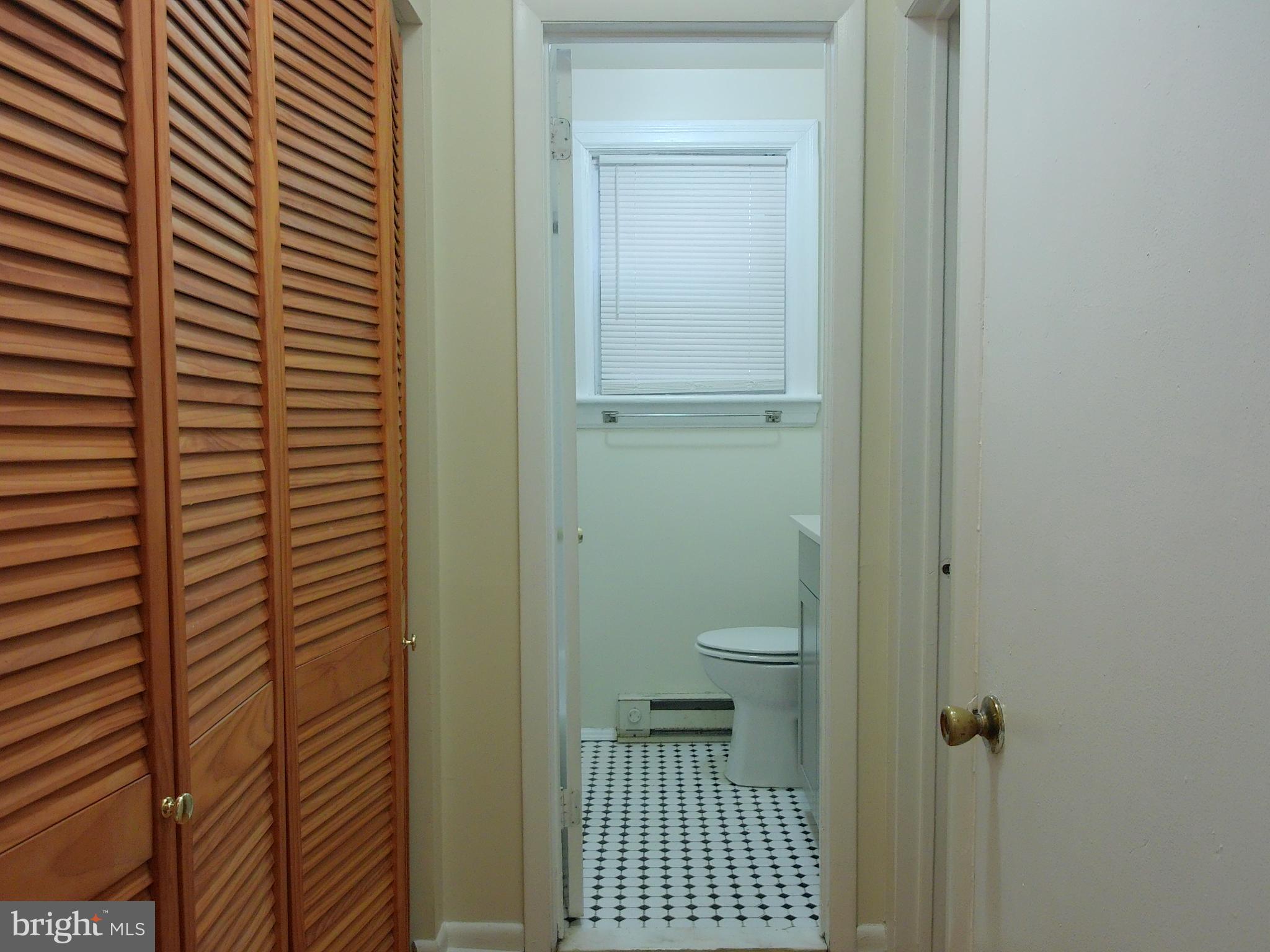 7870 Spring Avenue, Unit 1REAR Elkins Park, PA 19027 - Photo 9 of 14 Charming hallway leading to a bright bathroom.