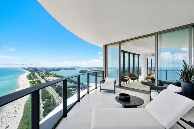 a living room with furniture and floor to ceiling windows