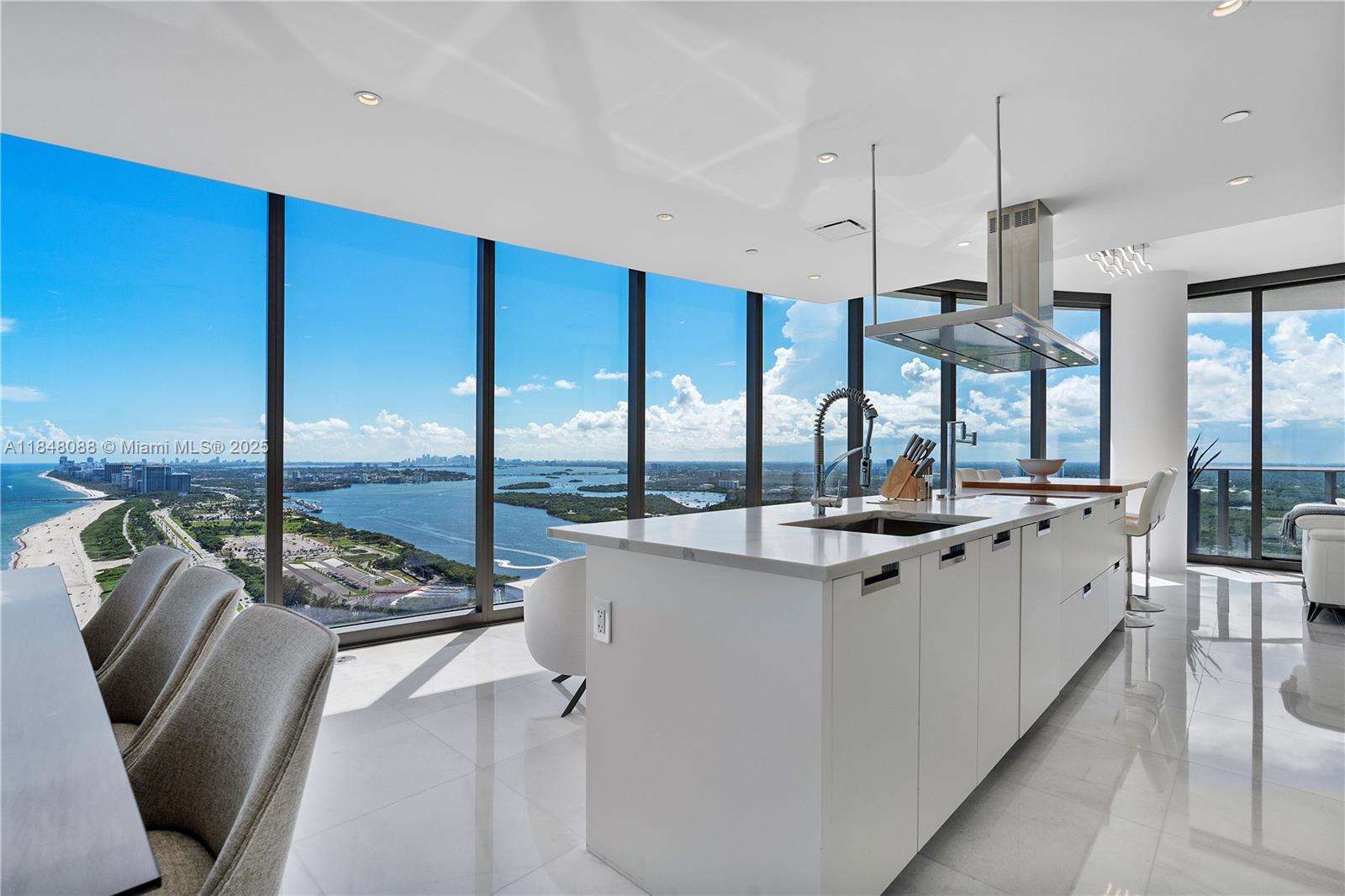 15701 Collins Avenue, Unit 3605 Sunny Isles Beach, FL 33160 - Photo 18 of 46 a kitchen with stainless steel appliances granite countertop a sink and a stove