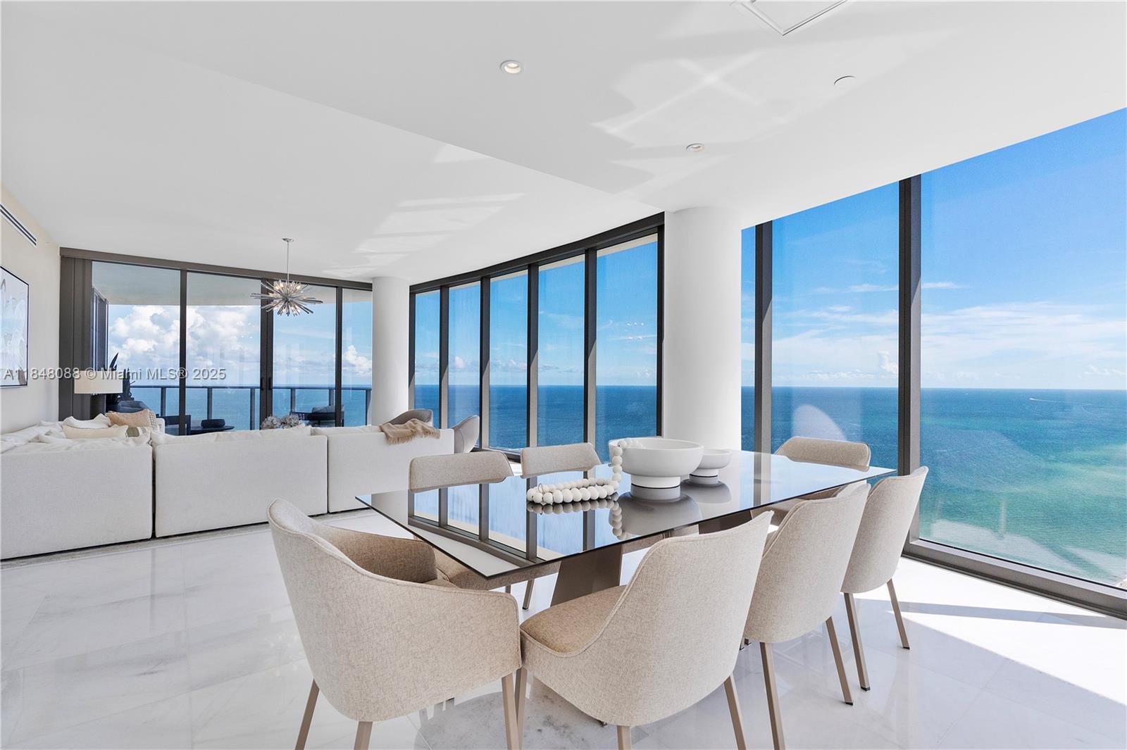 15701 Collins Avenue, Unit 3605 Sunny Isles Beach, FL 33160 - Photo 19 of 46 a dining room with furniture and a large window