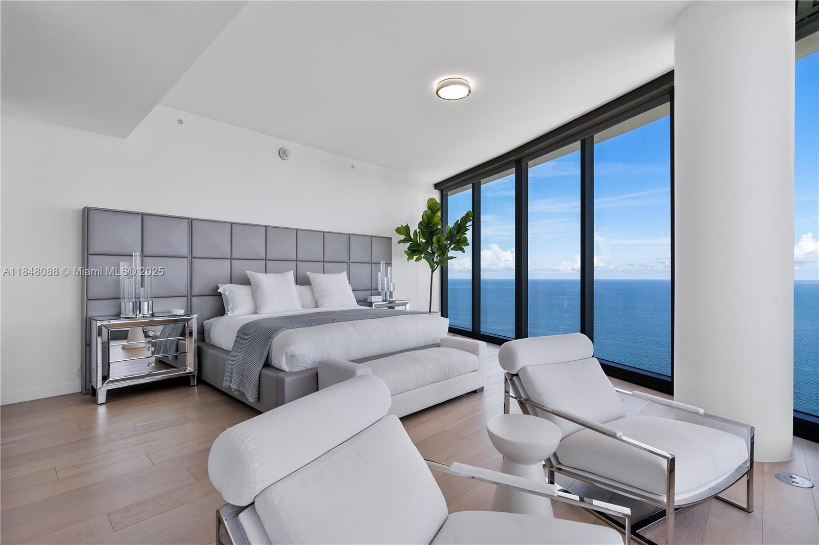 15701 Collins Avenue, Unit 3605 Sunny Isles Beach, FL 33160 - Photo 20 of 46 a bed room with a bed and a chair