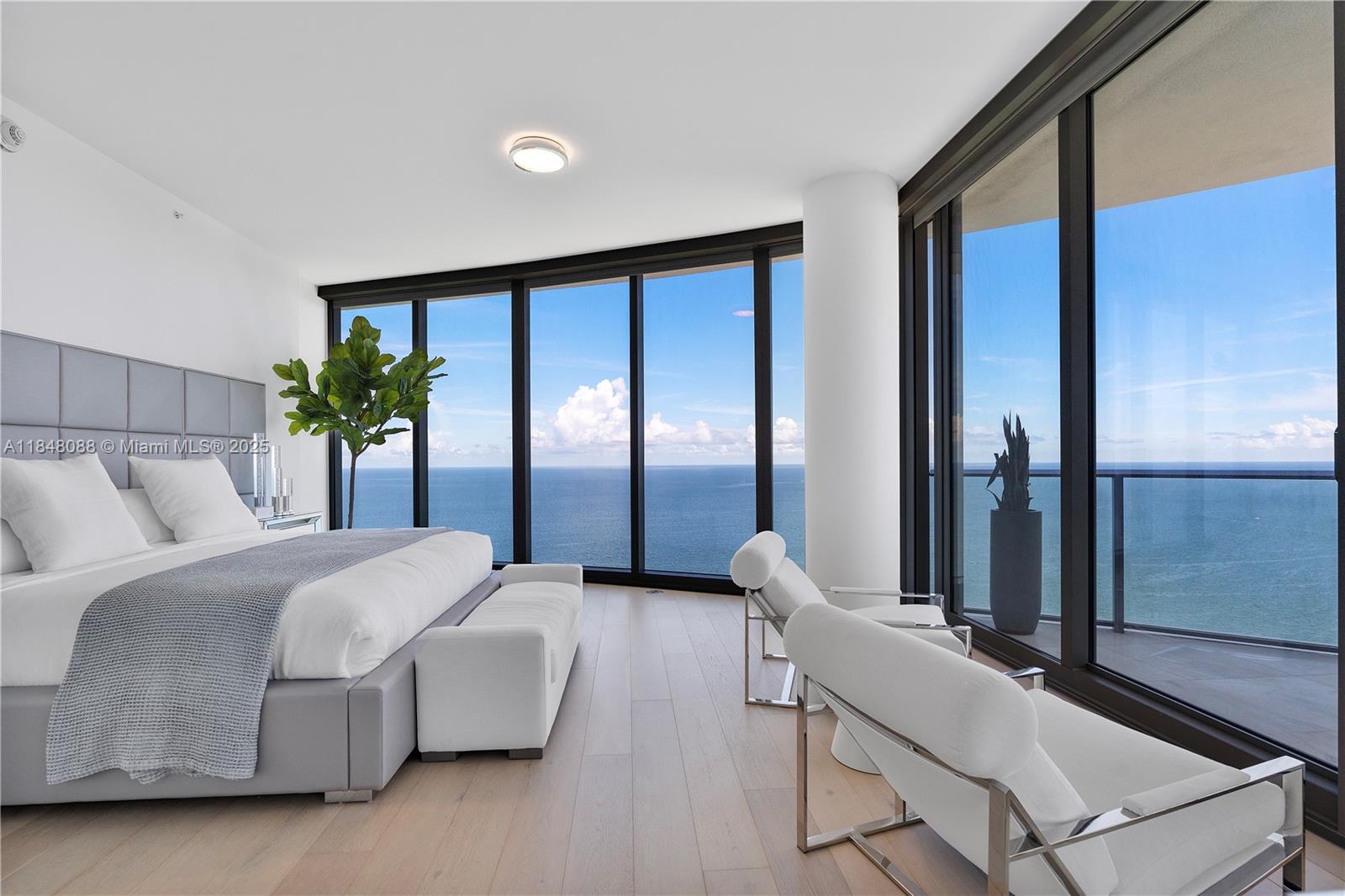 15701 Collins Avenue, Unit 3605 Sunny Isles Beach, FL 33160 - Photo 21 of 46 a bedroom with a large bed and a large window