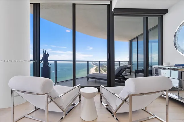 a living room with furniture and a floor to ceiling window