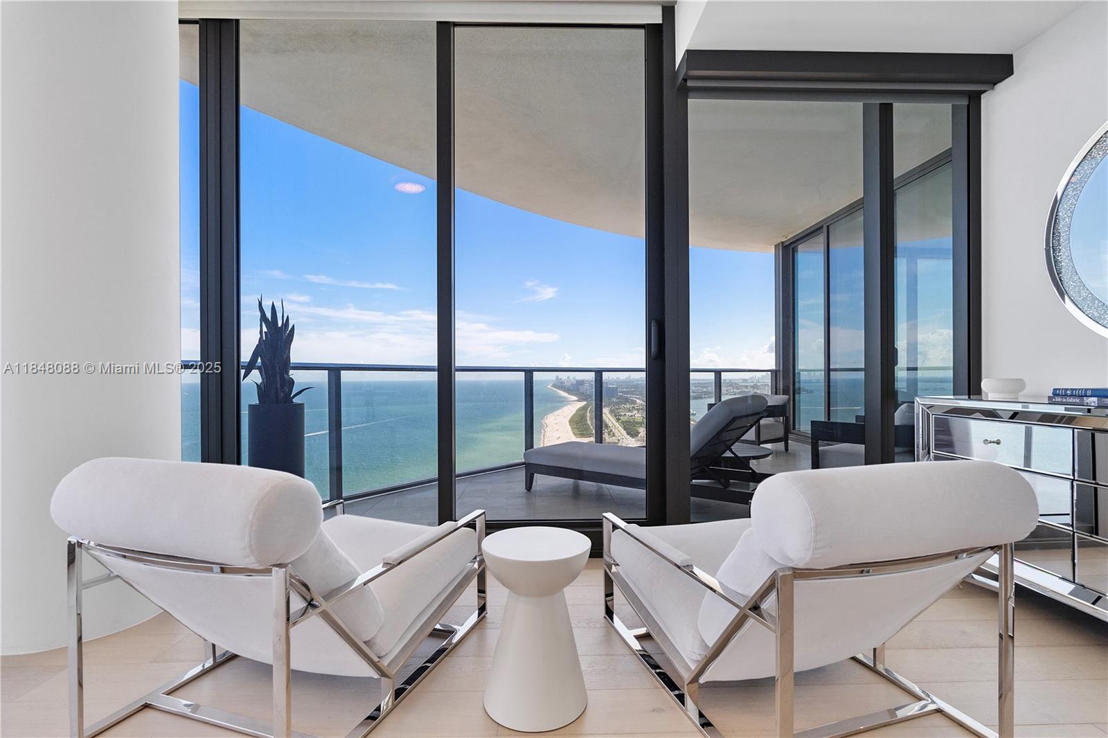 15701 Collins Avenue, Unit 3605 Sunny Isles Beach, FL 33160 - Photo 23 of 46 a living room with furniture and a floor to ceiling window