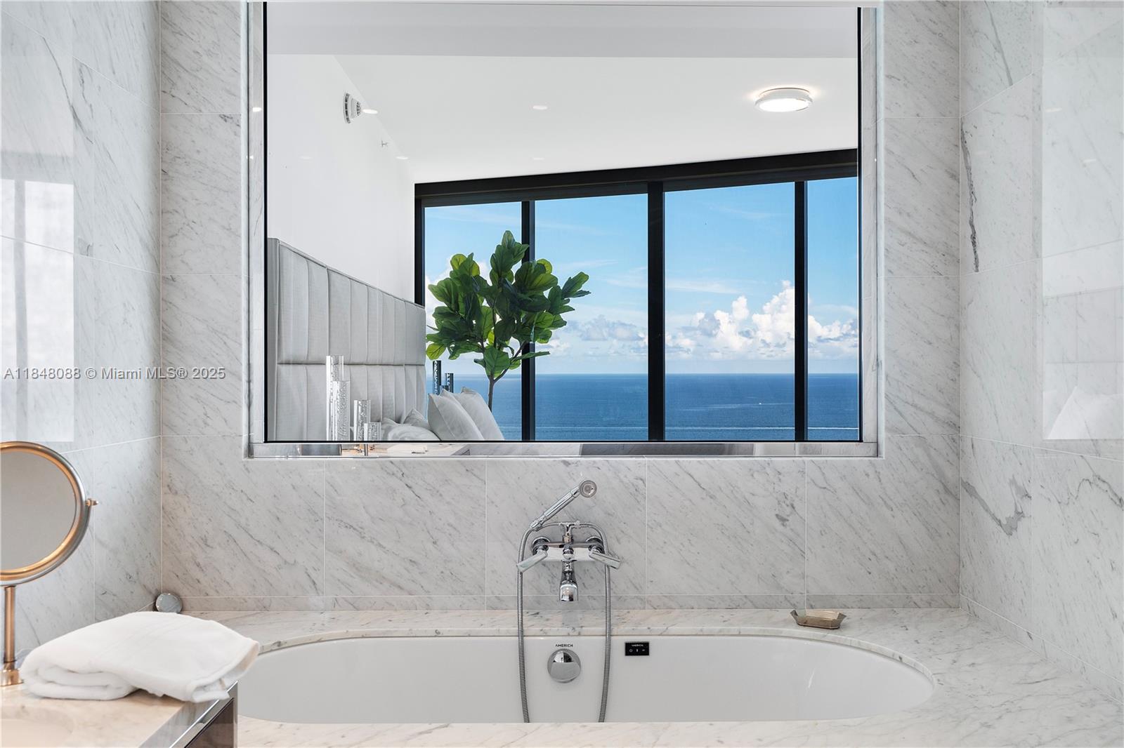 15701 Collins Avenue, Unit 3605 Sunny Isles Beach, FL 33160 - Photo 26 of 46 a bathroom with a bathtub and a potted plant