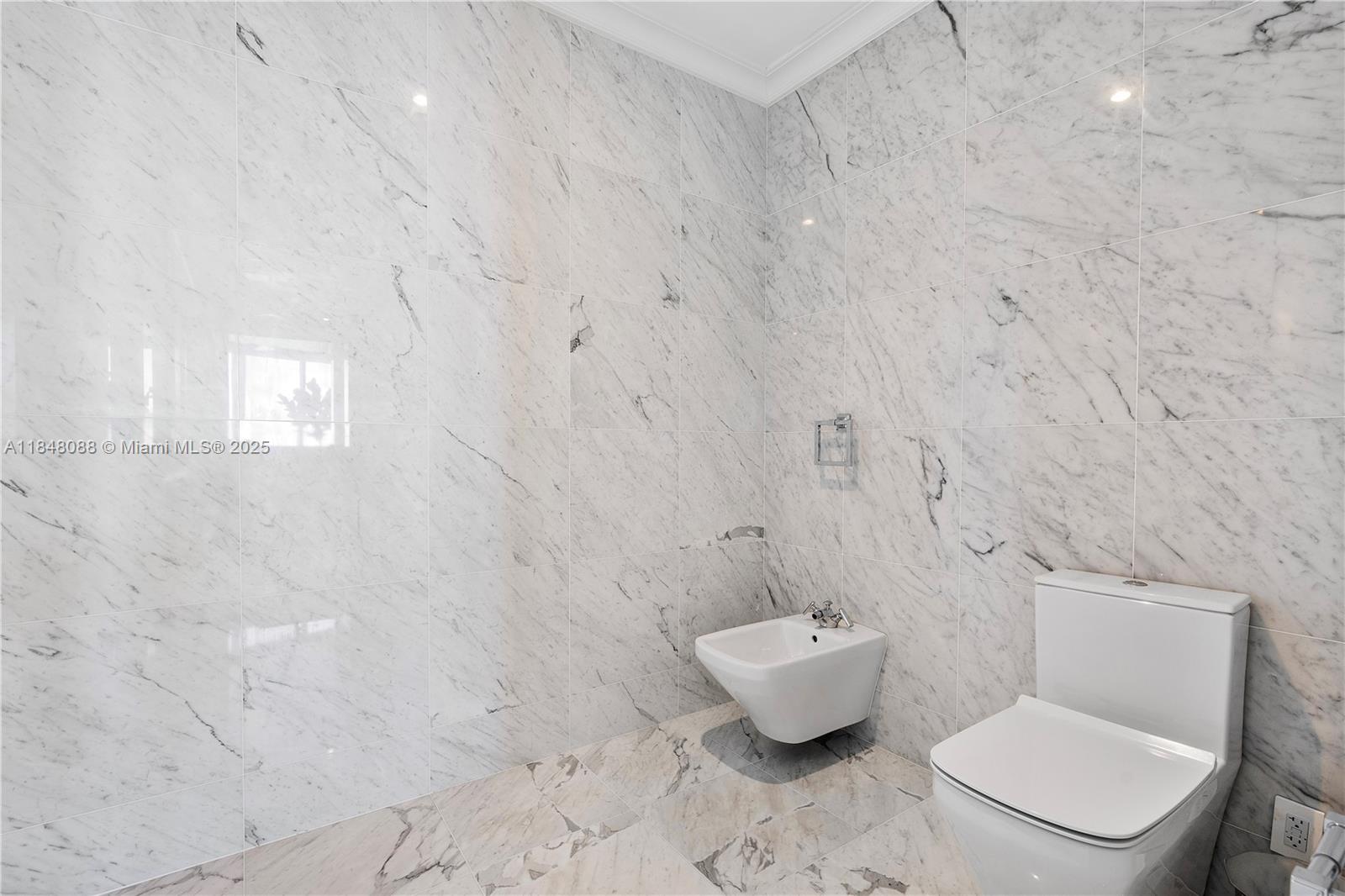 15701 Collins Avenue, Unit 3605 Sunny Isles Beach, FL 33160 - Photo 27 of 46 a white toilet sitting next to a white sink