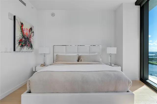 a bedroom with a bed and wall painting
