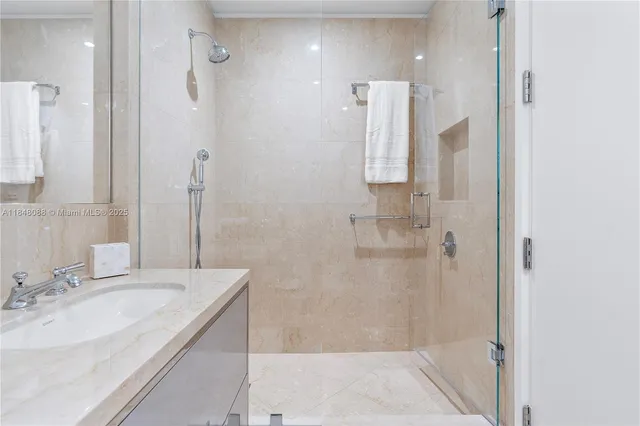 a bathroom with a granite countertop sink a shower and a mirror