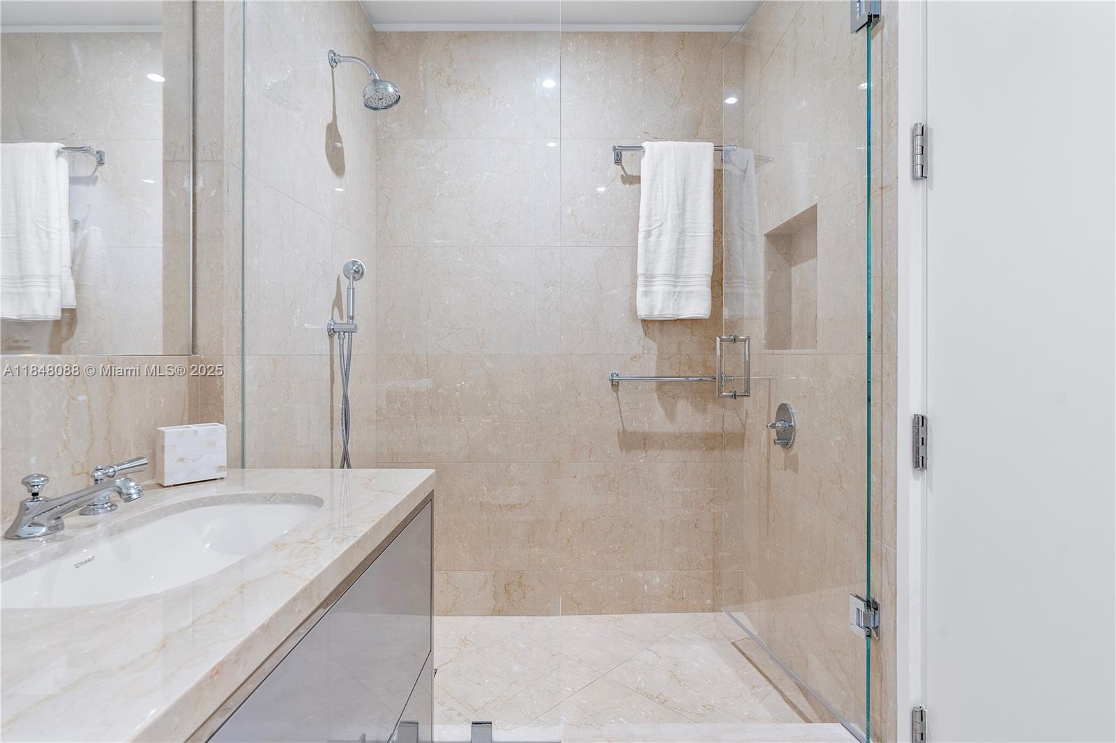 15701 Collins Avenue, Unit 3605 Sunny Isles Beach, FL 33160 - Photo 33 of 46 a bathroom with a granite countertop sink a shower and a mirror