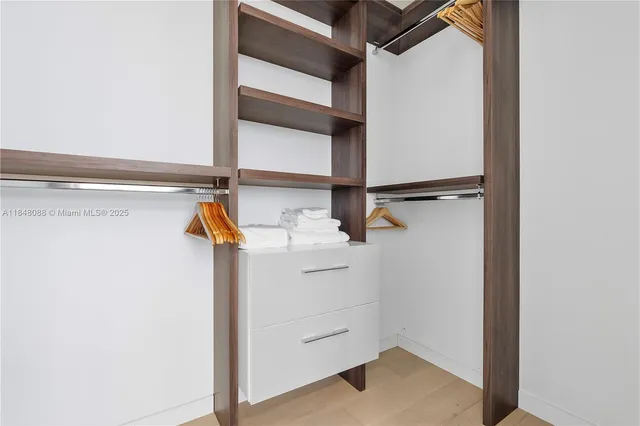 a view of walk in closet with empty racks