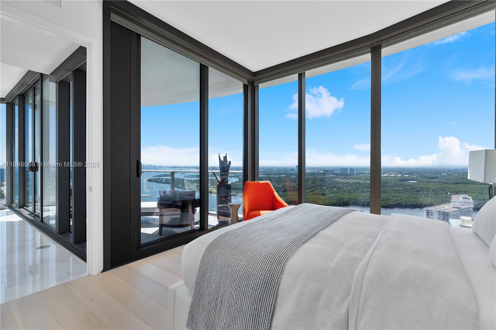 15701 Collins Avenue, Unit 3605 Sunny Isles Beach, FL 33160 - Photo 37 of 46 a bed sitting in front of a window with a balcony