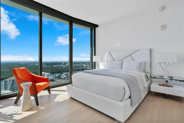a bedroom with a bed and city view