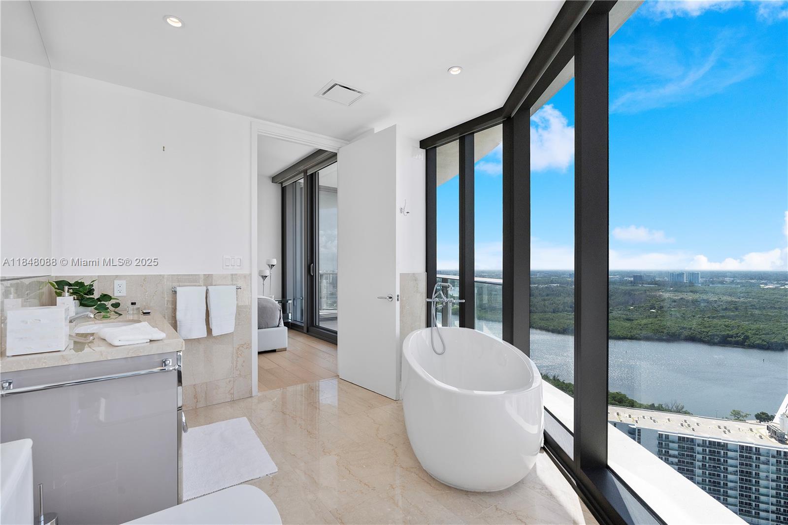 15701 Collins Avenue, Unit 3605 Sunny Isles Beach, FL 33160 - Photo 39 of 46 a living room with furniture and large windows