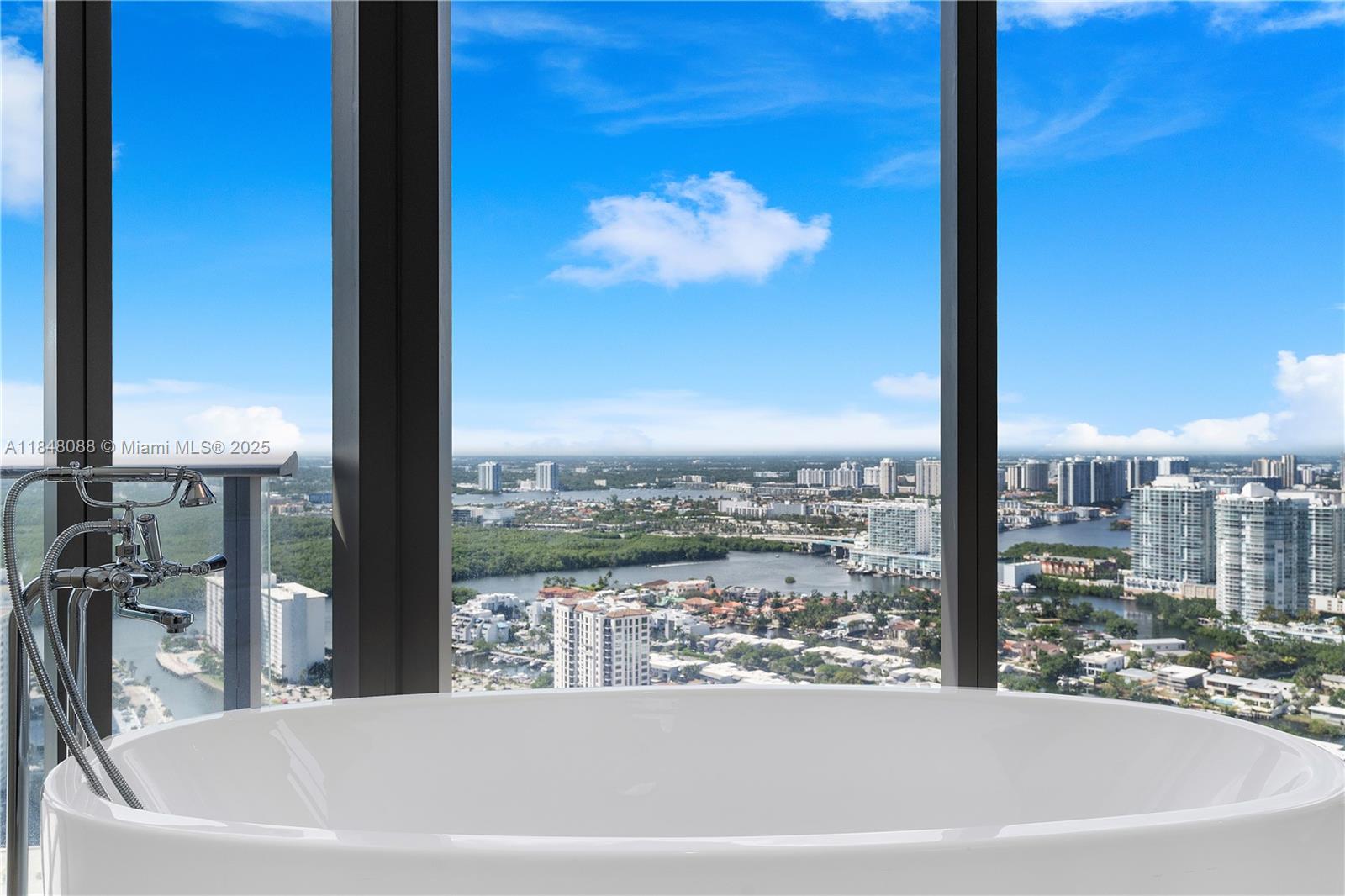 15701 Collins Avenue, Unit 3605 Sunny Isles Beach, FL 33160 - Photo 40 of 46 a view of a city from a bathtub