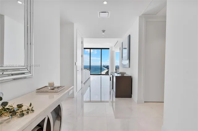a living room with a sink and a refrigerator