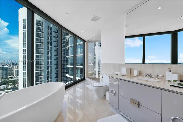 a bathroom with a granite countertop sink mirror and a bathtub