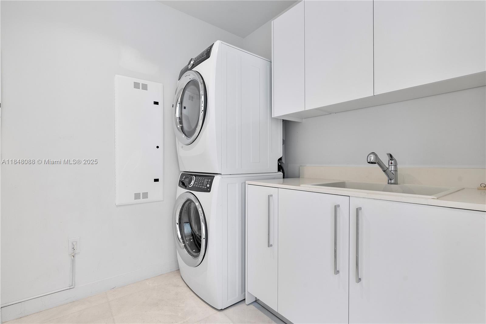 15701 Collins Avenue, Unit 3605 Sunny Isles Beach, FL 33160 - Photo 43 of 46 a utility room with dryer and washer