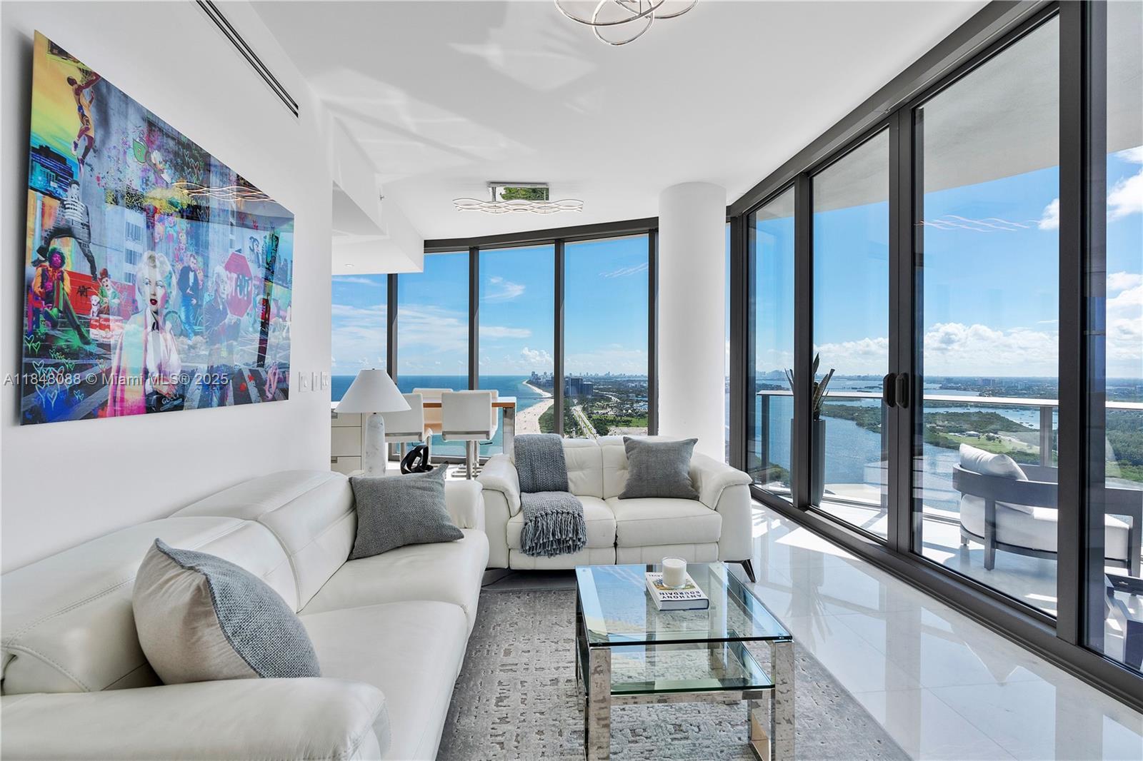 15701 Collins Avenue, Unit 3605 Sunny Isles Beach, FL 33160 - Photo 5 of 46 a living room with furniture and large windows