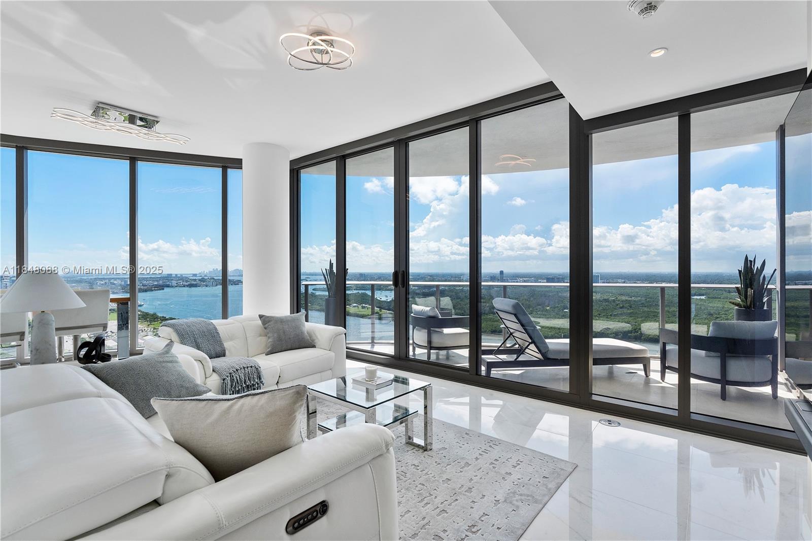 15701 Collins Avenue, Unit 3605 Sunny Isles Beach, FL 33160 - Photo 6 of 46 a living room with furniture and floor to ceiling windows