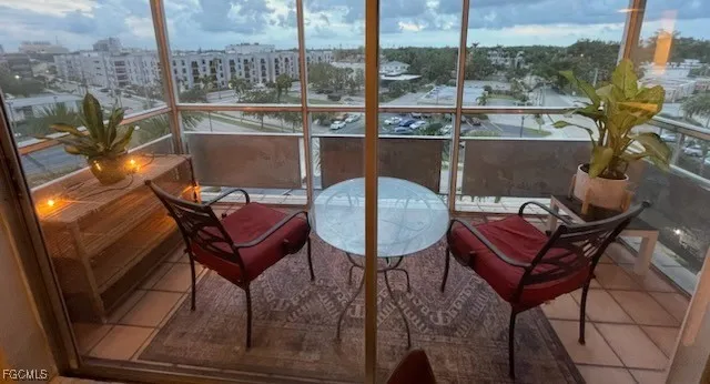 a view of a chairs and table in the balcony