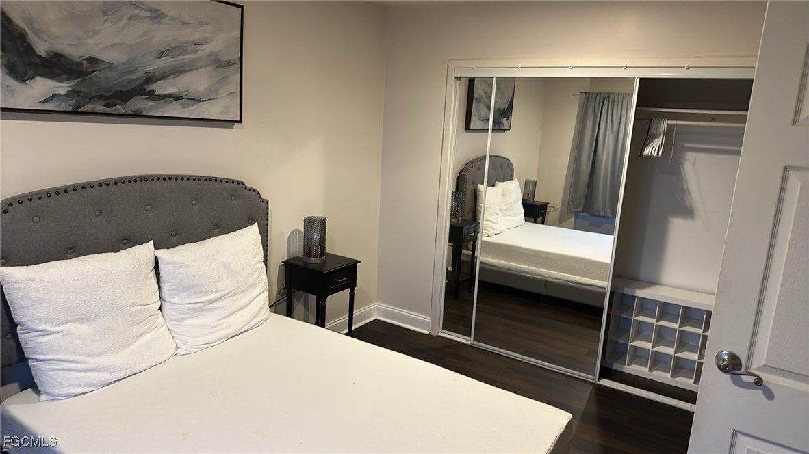 2350 West First Street, Unit 603 Fort Myers, FL 33901 - Photo 15 of 17 a bedroom with a bed and a refrigerator