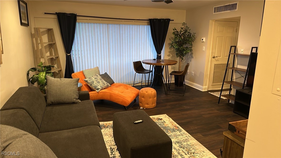 2350 West First Street, Unit 603 Fort Myers, FL 33901 - Photo 5 of 17 a living room with furniture and a wooden floor