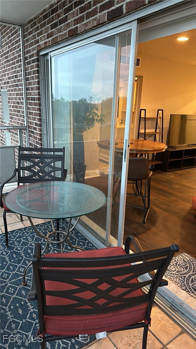 2350 West First Street, Unit 603 Fort Myers, FL 33901 - Photo 8 of 17 a view of a balcony with chairs and wooden floor