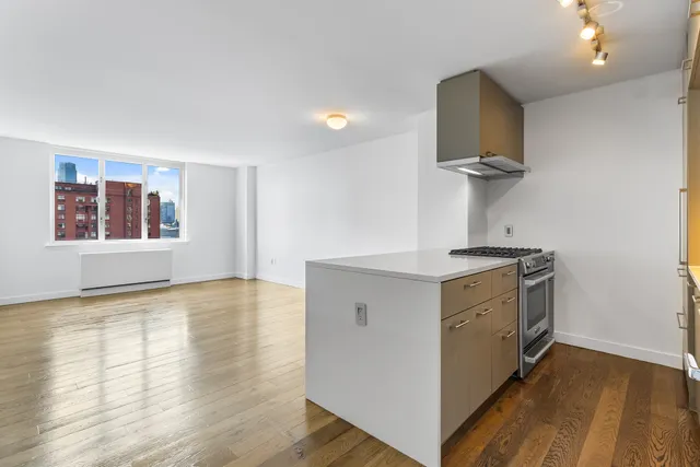 a view of a kitchen with a sink and wooden floor