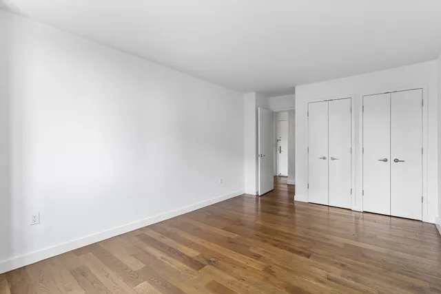 a view of an empty room and wooden floor