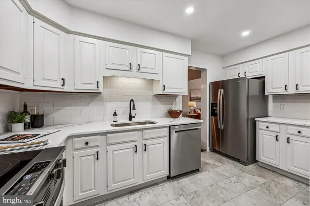 a kitchen with cabinets and stainless steel appliances