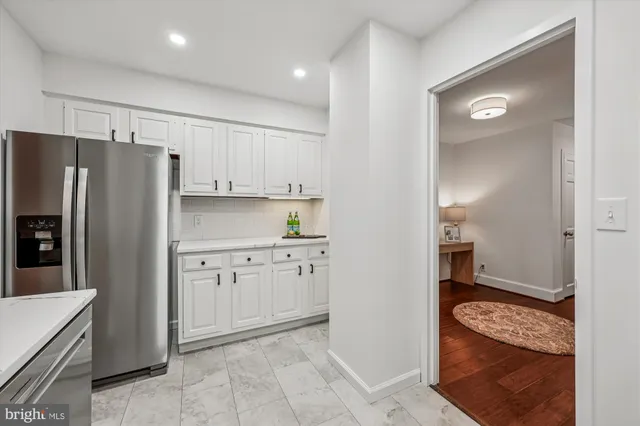 a kitchen with granite countertop cabinets and refrigerator