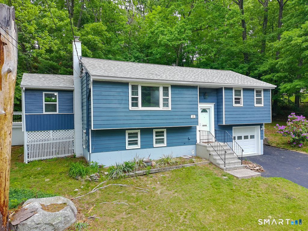 17 Rhoda Lane Bristol, CT 06010 - Photo 2 of 22 a front view of a house with a yard table and chairs