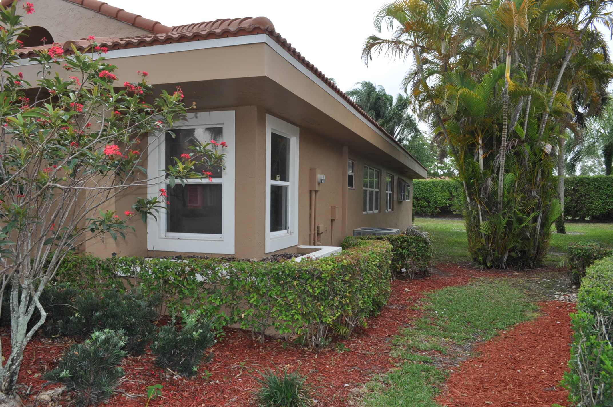 11094 Autoro Court Boca Raton, FL 33498 - Photo 2 of 17 a front view of a house with garden