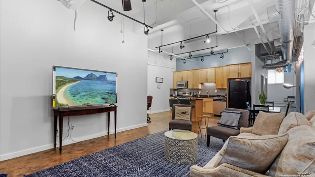 a kitchen with stainless steel appliances granite countertop a refrigerator a stove and a refrigerator with wooden floor