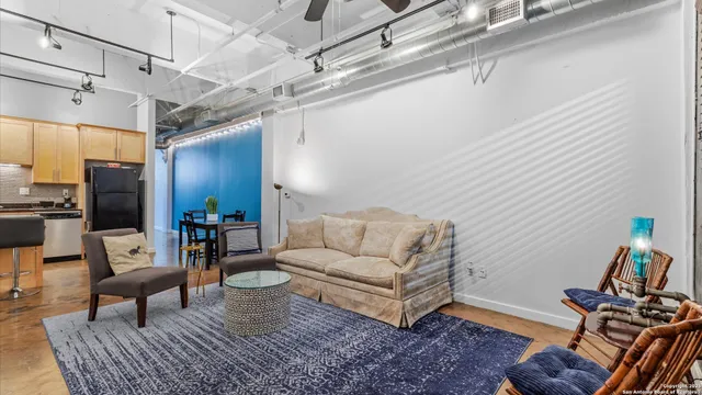 a kitchen with stainless steel appliances granite countertop a refrigerator a stove and a refrigerator with wooden floor