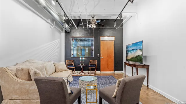 a kitchen with stainless steel appliances kitchen island granite countertop a refrigerator a stove a sink and chairs