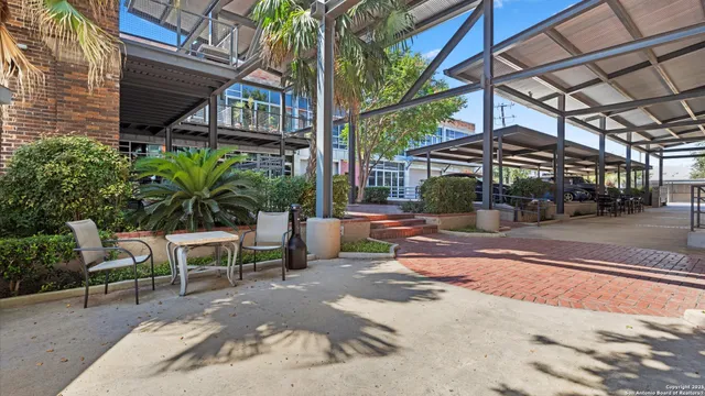 a view of a patio with table and chairs and potted plants