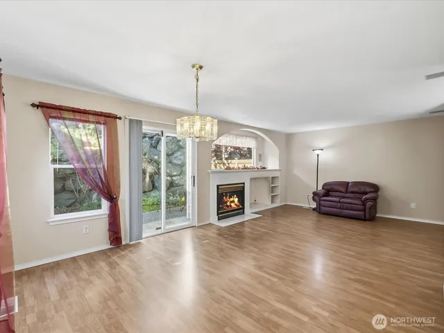 a view of an empty room with furniture and a fireplace