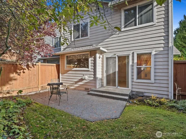 a view of a chairs and table in the backyard