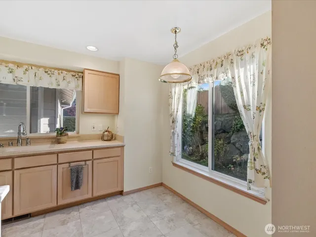 a kitchen with stainless steel appliances granite countertop a sink stove microwave and refrigerator