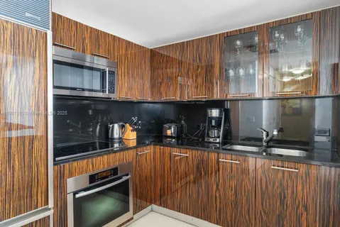 a kitchen with stainless steel appliances a sink and cabinets