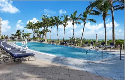 a view of a backyard and swimming pool