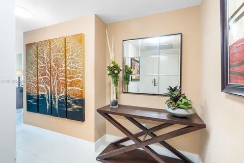 a room with wooden floor table and a window