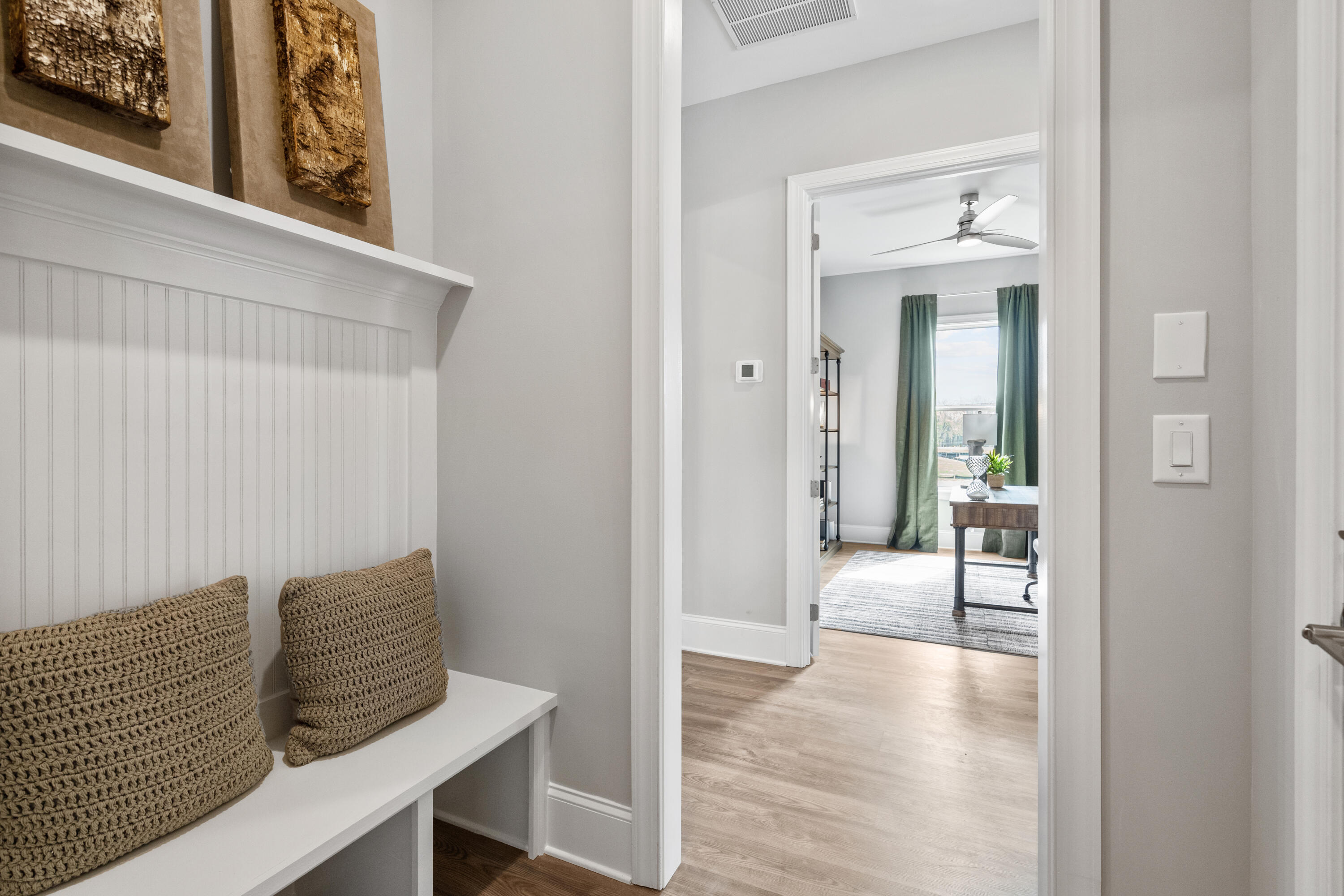160 Brizo Lane, Unit LOT 10 Santa Rosa Beach, FL 32459 - Photo 13 of 45 a view of a hallway with couch and wooden floor