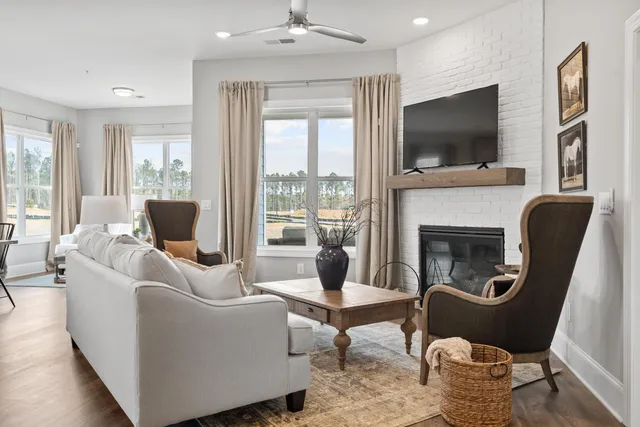 a living room with furniture fireplace and flat screen tv