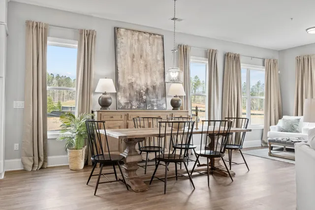 a view of a dining room with furniture window and wooden floor