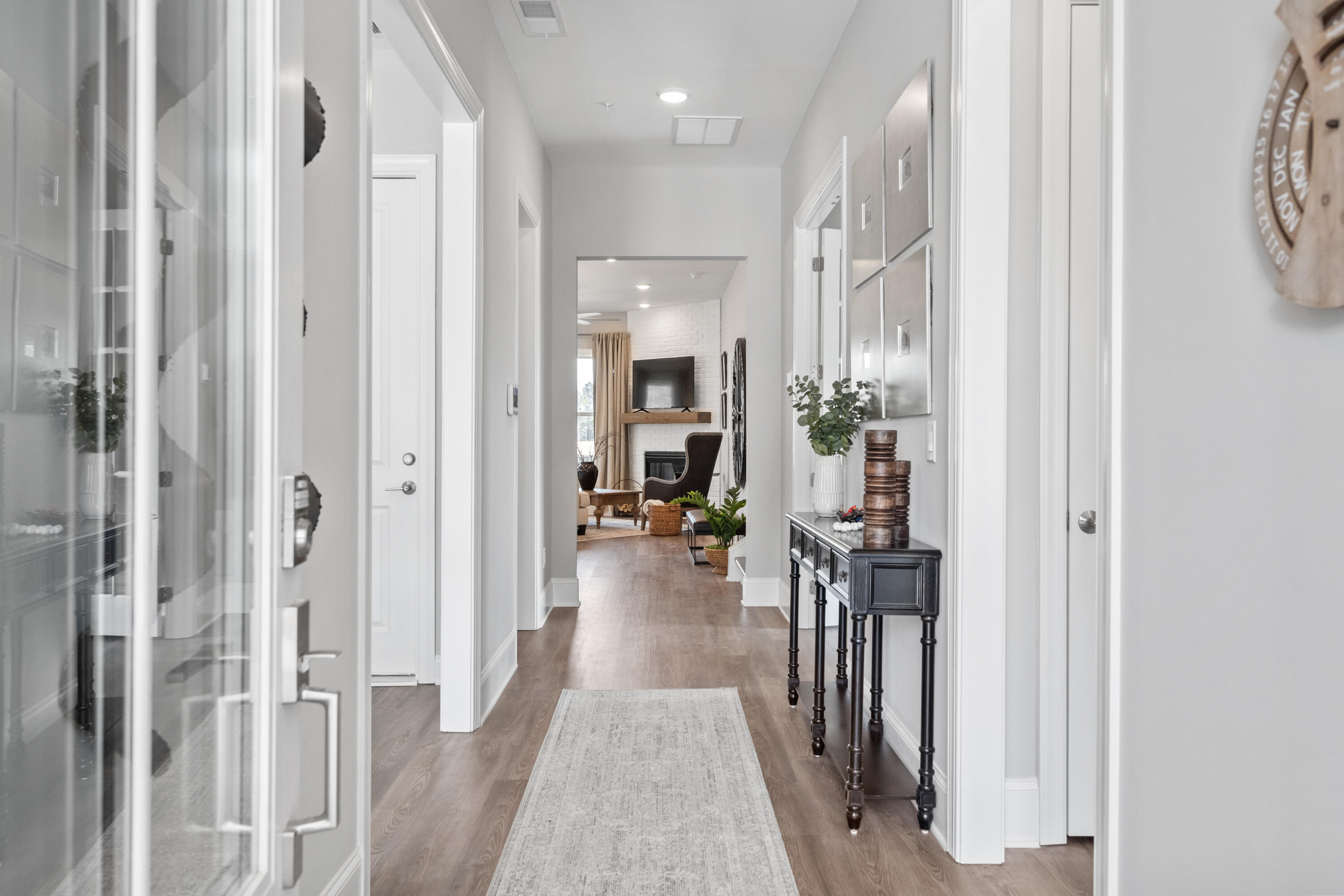 160 Brizo Lane, Unit LOT 10 Santa Rosa Beach, FL 32459 - Photo 3 of 45 a view of a hallway view with living room and wooden floor