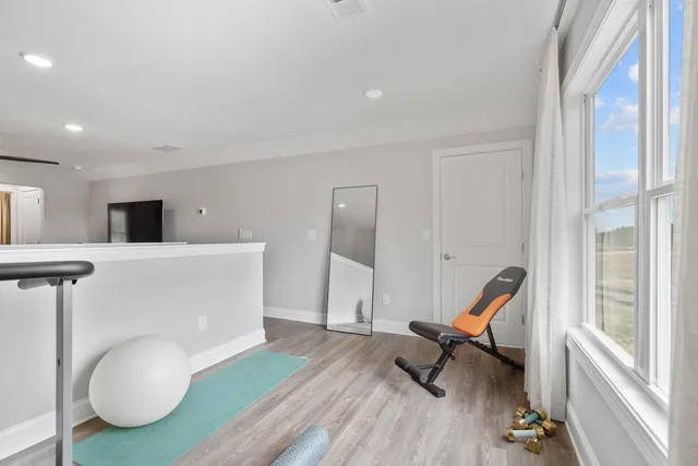 a view of a kitchen with furniture and wooden floor